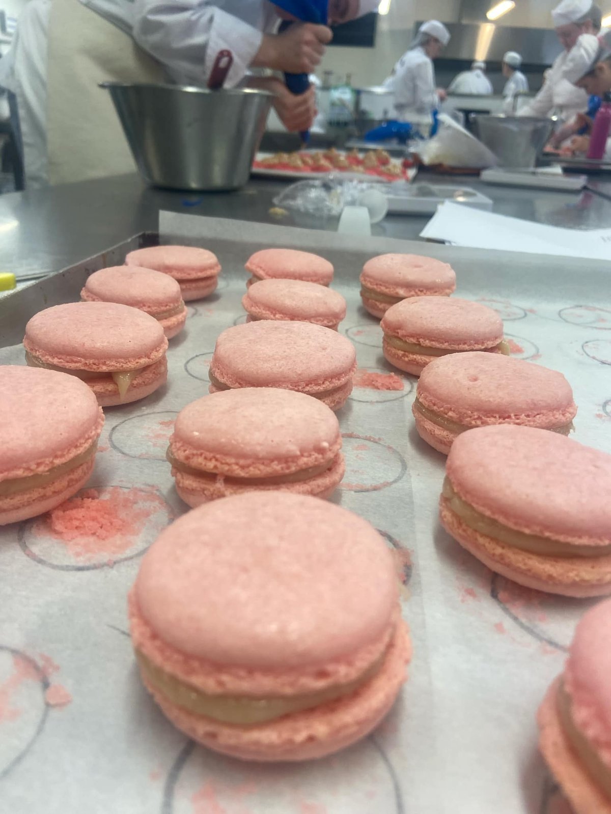 Gabby hand-piping macarons in the college training kitchen